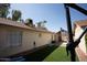 Backyard view showing artificial turf and a partially visible patio at 8520 W Palm Ln # 1049, Phoenix, AZ 85037