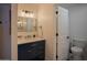 Modern bathroom featuring a navy blue vanity and a sleek, frameless mirror at 8520 W Palm Ln # 1049, Phoenix, AZ 85037