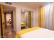 Cozy bedroom with mirrored closet and yellow accents at 8520 W Palm Ln # 1049, Phoenix, AZ 85037