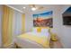 Second bedroom with a queen-size bed and yellow accents at 8520 W Palm Ln # 1049, Phoenix, AZ 85037