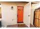 Inviting orange front door with screen door and cactus doormat at 8520 W Palm Ln # 1049, Phoenix, AZ 85037