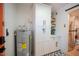 Hallway with water heater and modern white cabinets at 8520 W Palm Ln # 1049, Phoenix, AZ 85037