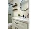 Modern bathroom with white vanity, floating shelves, and walk-in shower at 10301 W Cheryl Dr, Sun City, AZ 85351