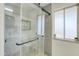 Modern bathroom with a glass shower, updated fixtures and soothing color scheme at 10301 W Cheryl Dr, Sun City, AZ 85351