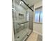 Modern bathroom with a frameless glass shower and gray tile at 10301 W Cheryl Dr, Sun City, AZ 85351