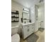 Main bathroom with double vanity, tall cabinets, and modern fixtures at 10301 W Cheryl Dr, Sun City, AZ 85351