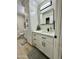 Bathroom features a vanity with quartz countertop and modern lighting at 10301 W Cheryl Dr, Sun City, AZ 85351