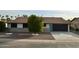 Front view of a remodeled home with a teal door and landscaping at 10301 W Cheryl Dr, Sun City, AZ 85351