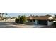 House exterior showcasing a teal door and dark garage door at 10301 W Cheryl Dr, Sun City, AZ 85351