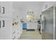 Modern kitchen with white cabinets, blue dishwasher, and quartz countertops at 10301 W Cheryl Dr, Sun City, AZ 85351