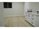 Modern kitchen featuring white shaker cabinets and quartz countertops at 10301 W Cheryl Dr, Sun City, AZ 85351