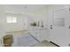 Laundry room with white cabinets and a door to the outside at 10301 W Cheryl Dr, Sun City, AZ 85351