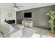 Living room boasts a dark-gray feature wall, new flooring, and a ceiling fan at 10301 W Cheryl Dr, Sun City, AZ 85351