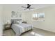 Main bedroom with gray bedding and wood-look floors at 10301 W Cheryl Dr, Sun City, AZ 85351