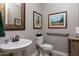 Elegant bathroom featuring a pedestal sink and framed artwork at 10317 E Tillman Ave, Mesa, AZ 85212