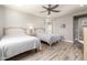 Guest bedroom with two twin beds, ceiling fan, and light wood flooring at 10317 E Tillman Ave, Mesa, AZ 85212