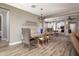 Open dining room with kitchen view, wood table and chandelier at 10317 E Tillman Ave, Mesa, AZ 85212