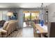 Bright dining room with wooden table, chandelier, and view of backyard pool at 10317 E Tillman Ave, Mesa, AZ 85212