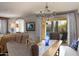 Bright dining room with wooden table, chandelier, and view of backyard pool at 10317 E Tillman Ave, Mesa, AZ 85212