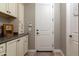 Bright laundry room with ample cabinetry and granite countertops at 10317 E Tillman Ave, Mesa, AZ 85212