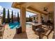 Relaxing pool area with covered patio, fire pit, and lounge chairs at 10317 E Tillman Ave, Mesa, AZ 85212