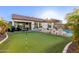 Luxury backyard oasis with putting green, pool, and patio at 10496 W Cottontail Ln, Peoria, AZ 85383