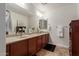 Double vanity bathroom with a large mirror and plenty of counter space at 10496 W Cottontail Ln, Peoria, AZ 85383