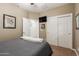 Comfortable bedroom with a full-size bed and double door closet at 10496 W Cottontail Ln, Peoria, AZ 85383