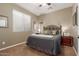 Cozy bedroom with a full-size bed and built-in shelving at 10496 W Cottontail Ln, Peoria, AZ 85383