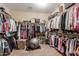 Large walk-in closet with ample shelving and hanging space at 10496 W Cottontail Ln, Peoria, AZ 85383