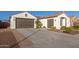 Two-car garage, landscaped yard, and neutral color scheme at 10496 W Cottontail Ln, Peoria, AZ 85383