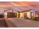 Single story home with attached garage and landscaped front yard at 10496 W Cottontail Ln, Peoria, AZ 85383