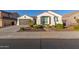 Single-story home with attached garage, landscaping, and a charming front entrance at 10496 W Cottontail Ln, Peoria, AZ 85383