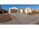 Two-car garage, landscaped yard, and neutral color scheme at 10496 W Cottontail Ln, Peoria, AZ 85383