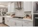 Modern kitchen with white cabinets and stainless steel appliances at 10496 W Cottontail Ln, Peoria, AZ 85383