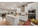 Modern kitchen with white cabinets, island, and stainless steel appliances at 10496 W Cottontail Ln, Peoria, AZ 85383