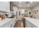 Modern kitchen with white cabinets, stainless steel appliances, and an island at 10496 W Cottontail Ln, Peoria, AZ 85383