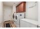 Laundry room with washer, dryer, and cabinets at 10496 W Cottontail Ln, Peoria, AZ 85383