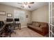 Home office with built-in desk and comfortable sofa at 10496 W Cottontail Ln, Peoria, AZ 85383