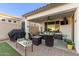 Covered patio with seating area, grill, and TV at 10496 W Cottontail Ln, Peoria, AZ 85383