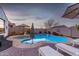 Enjoy this kidney shaped pool and spa with lounge chairs at 10496 W Cottontail Ln, Peoria, AZ 85383