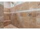 Large walk-in shower with neutral tile and built-in bench seat at 10496 W Cottontail Ln, Peoria, AZ 85383