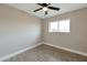 Bright bedroom with a ceiling fan and large window at 11411 E Crescent Ave, Mesa, AZ 85208