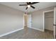 Well-lit bedroom with ceiling fan and wood-look tile flooring at 11411 E Crescent Ave, Mesa, AZ 85208