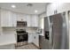 Updated kitchen with white shaker cabinets and stainless steel appliances at 11411 E Crescent Ave, Mesa, AZ 85208