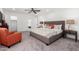 King-size bed, orange chair, and walk-in closet at 1152 W Greenway Dr, Tempe, AZ 85282