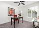 Home office with dark wood desk and red accent chair at 1152 W Greenway Dr, Tempe, AZ 85282