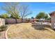 Large backyard with grassy area, pool, and mature trees at 11553 N 76Th Dr, Peoria, AZ 85345