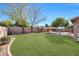 Expansive grassy backyard with a pool and lush landscaping at 11553 N 76Th Dr, Peoria, AZ 85345