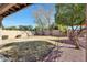 Spacious backyard with a grassy area and covered patio at 11553 N 76Th Dr, Peoria, AZ 85345